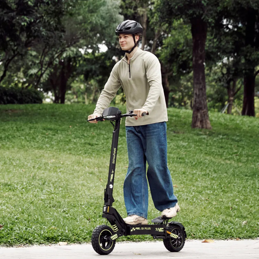 Rider on an isinwheel D1 Plus electric scooter in a park