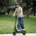 Rider on an isinwheel D1 Plus electric scooter in a park