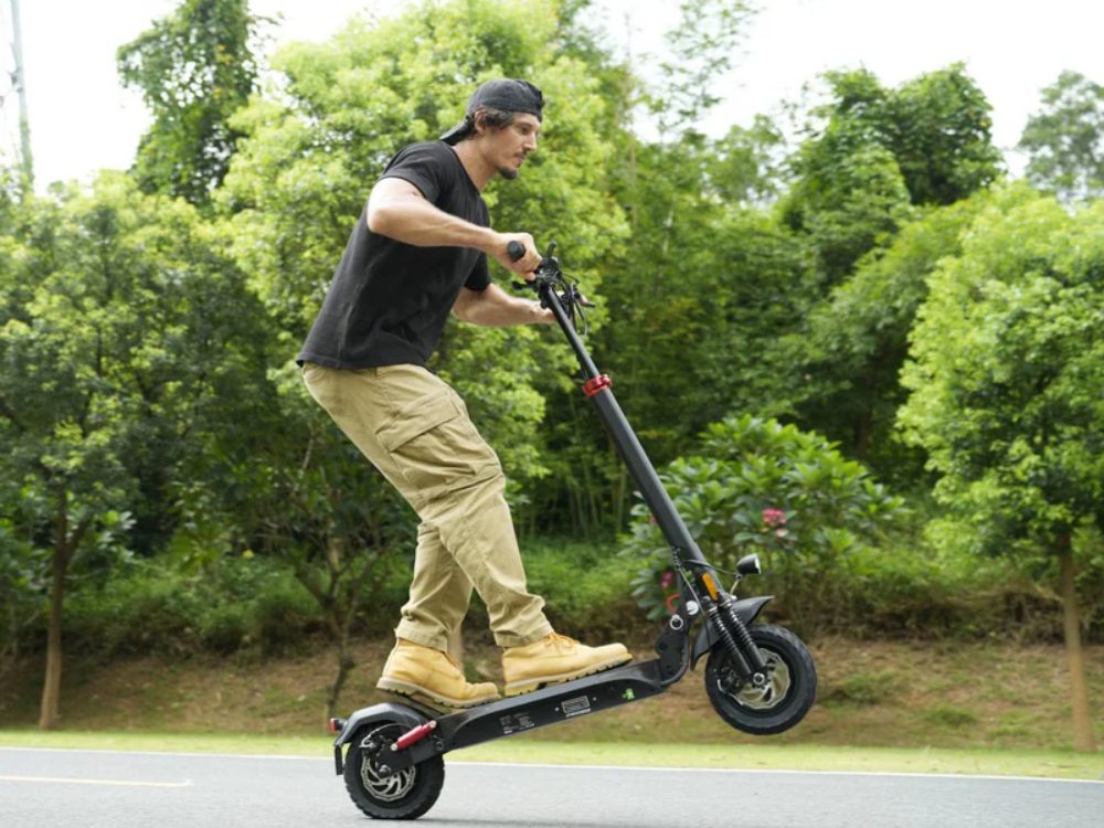 A rider jumping an isinwheel off-road scooter in a park