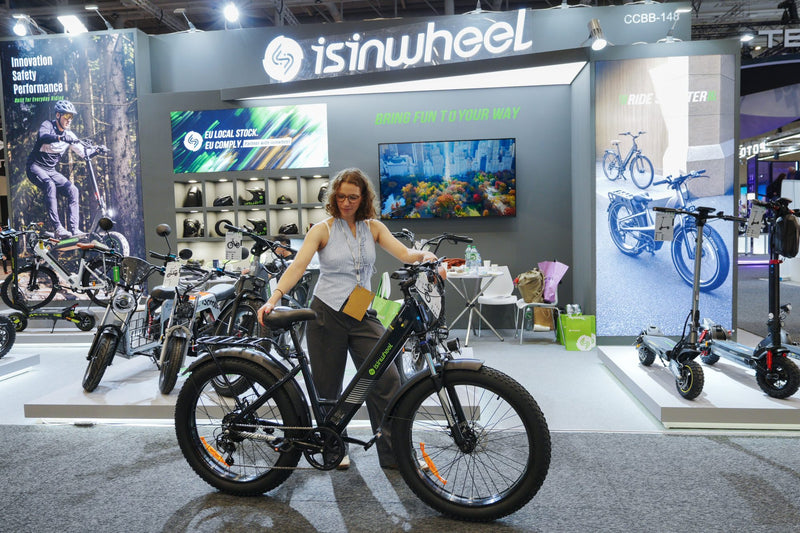 The isinwheel stand at IFA 2026 in Berlin, with the M60 fat-tyre e-bike in front
